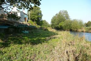 The river running alongside the cumbrian house being landscaped The river running alongside the cumbrian house being landscaped
